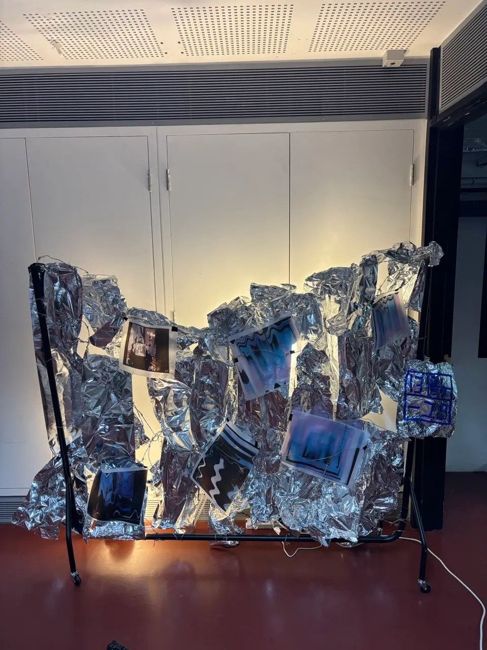 Wind, Metal, barbwire, foil, archival inkjet prints, light bulbs, 240 x 20 x 160cm, 2025 by Paul Tymoshenko